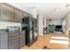 Open kitchen with black refrigerator and view into the living room space at 815 Clearbrook Rd, Matthews, NC 28105