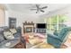 Living room features fireplace, hardwood floors, ceiling fan and large windows at 815 Clearbrook Rd, Matthews, NC 28105