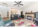 Living room with fireplace, ceiling fan, and large windows at 815 Clearbrook Rd, Matthews, NC 28105