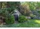 Charming garden shed surrounded by lush greenery in a well-maintained backyard at 815 Clearbrook Rd, Matthews, NC 28105
