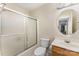 Bright bathroom featuring a shower with glass doors, toilet, and vanity with sink at 8734 Meadowmont View Dr, Charlotte, NC 28269