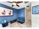 Bedroom features blue walls, artwork, ceiling fan and a dog kennel at 8734 Meadowmont View Dr, Charlotte, NC 28269
