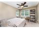 Bright bedroom with neutral walls, a ceiling fan, large window, and minimal furnishings at 8734 Meadowmont View Dr, Charlotte, NC 28269