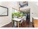 Dining area with modern table and view of the kitchen, next to sliding glass door at 8734 Meadowmont View Dr, Charlotte, NC 28269