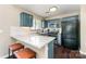 Modern kitchen with granite countertops, breakfast bar, and stainless steel appliances at 8734 Meadowmont View Dr, Charlotte, NC 28269