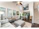 Open-concept living room with dining area, hardwood floors, and lots of natural light at 8734 Meadowmont View Dr, Charlotte, NC 28269