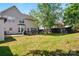 Spacious backyard with patio, grill, and mature tree at 8833 Cavonnier Ln, Charlotte, NC 28216