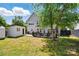 Well-maintained backyard with a deck, shed, lush grass, and plenty of space for outdoor activities at 8833 Cavonnier Ln, Charlotte, NC 28216