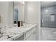 Elegant bathroom featuring marble countertops, brushed gold fixtures, and tiled walls with a modern design at 8833 Cavonnier Ln, Charlotte, NC 28216