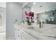 Bright bathroom featuring double sinks, marble countertops, and modern fixtures at 8833 Cavonnier Ln, Charlotte, NC 28216