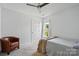 This bedroom has a ceiling fan, a window, and an accent chair at 8833 Cavonnier Ln, Charlotte, NC 28216