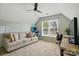 Bonus room with a large window, comfortable couch, desk, and an arcade game perfect for entertainment at 8833 Cavonnier Ln, Charlotte, NC 28216