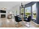Inviting dining area with a glass table, comfortable seating, and abundant natural light at 8833 Cavonnier Ln, Charlotte, NC 28216