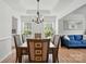Dining room with a view to the living room, a chandelier, and seating for six at 8833 Cavonnier Ln, Charlotte, NC 28216