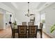 Dining room with a chandelier, hardwood floors, and seating for six at 8833 Cavonnier Ln, Charlotte, NC 28216