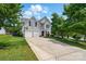 Charming two-story home with a two-car garage, well-manicured lawn, and an extended concrete driveway at 8833 Cavonnier Ln, Charlotte, NC 28216