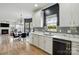 Modern kitchen with stainless steel appliances and an adjacent living area, ideal for entertaining at 8833 Cavonnier Ln, Charlotte, NC 28216