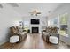 Inviting living room featuring a fireplace, wood floors, and two comfortable sofas at 8833 Cavonnier Ln, Charlotte, NC 28216