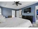 Blue primary bedroom with a tray ceiling, dark furniture, and ensuite bath at 8833 Cavonnier Ln, Charlotte, NC 28216