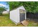 Sturdy outbuilding with gray doors and ramp access, offering additional storage at 8833 Cavonnier Ln, Charlotte, NC 28216