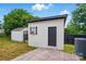 Charming outbuilding with a brick patio and modern door, ideal for storage or hobbies at 8833 Cavonnier Ln, Charlotte, NC 28216