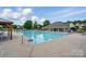 Large community pool with clear blue water and a screened-in shelter at 8833 Cavonnier Ln, Charlotte, NC 28216