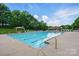 Community pool with clear blue water, gazebo, and lounge chairs at 8833 Cavonnier Ln, Charlotte, NC 28216