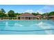 Community pool featuring a large swimming area, adjacent covered seating, and ample lounging space at 8833 Cavonnier Ln, Charlotte, NC 28216