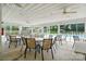 Enclosed seating area at community pool with tables, chairs, ceiling fans, and views of pool at 8833 Cavonnier Ln, Charlotte, NC 28216