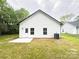 View of the backyard with a patio, grassy area, and white exterior at Lot 1 New Pineola Rd, Charlotte, NC 28208