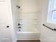 A full bathroom offers a shower-tub combo with a built-in shelving and black fixtures at Lot 1 New Pineola Rd, Charlotte, NC 28208