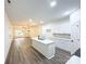 Open concept kitchen featuring white cabinets, stainless steel appliances, island with sink and wood-look flooring at Lot 1 New Pineola Rd, Charlotte, NC 28208