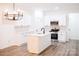 Modern kitchen featuring white cabinets, stainless steel appliances, an island, and stylish lighting at Lot 1 New Pineola Rd, Charlotte, NC 28208