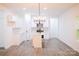 Modern kitchen featuring white cabinets, stainless steel appliances, an island, and stylish lighting at Lot 1 New Pineola Rd, Charlotte, NC 28208