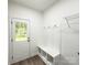Mud room featuring built-in bench with storage and hooks with door to exterior at Lot 1 New Pineola Rd, Charlotte, NC 28208