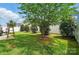 The property features a well-manicured backyard with lush lawn and various trees at 1026 Slew O Gold Ln, Indian Trail, NC 28079