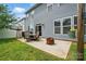 The backyard features a patio with an outdoor dining set and a fire pit, perfect for relaxation at 1026 Slew O Gold Ln, Indian Trail, NC 28079