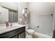 Bathroom features a sink, toilet, shower with curtain, and shelving for toiletries at 1026 Slew O Gold Ln, Indian Trail, NC 28079