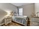 Comfortable bedroom featuring a bed, nightstand, hardwood flooring, natural light, and tasteful décor at 1026 Slew O Gold Ln, Indian Trail, NC 28079