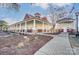 Welcoming clubhouse exterior featuring a covered porch with stately columns and professional landscaping at 1026 Slew O Gold Ln, Indian Trail, NC 28079