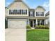 Inviting two-story home with a spacious garage and beautifully landscaped front yard with lush green grass at 1026 Slew O Gold Ln, Indian Trail, NC 28079