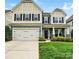Charming home with an attached garage, lush landscaping, and a well-maintained lawn at 1026 Slew O Gold Ln, Indian Trail, NC 28079