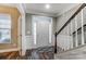 Bright foyer featuring elegant wainscoting, a staircase, and a stylish front door with sidelights at 1026 Slew O Gold Ln, Indian Trail, NC 28079