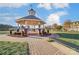 Picturesque community gazebo with brick accents and manicured landscaping, perfect for outdoor gatherings at 1026 Slew O Gold Ln, Indian Trail, NC 28079