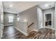 Spacious upstairs hallway with hardwood floors, neutral paint, a banister, and multiple doorways at 1026 Slew O Gold Ln, Indian Trail, NC 28079