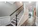 Inviting hallway with hardwood floors and detailed trim, leading to staircase and dining area at 1026 Slew O Gold Ln, Indian Trail, NC 28079