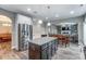 Open kitchen features granite countertops, stainless steel appliances, and a spacious island for food preparation at 1026 Slew O Gold Ln, Indian Trail, NC 28079