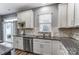 Kitchen features stainless steel appliances, granite countertops, a sink, and an adjacent door to the outside at 1026 Slew O Gold Ln, Indian Trail, NC 28079