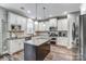 A modern kitchen featuring white cabinets, granite countertops, stainless steel appliances and an island at 1026 Slew O Gold Ln, Indian Trail, NC 28079
