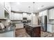A well-equipped kitchen with white cabinets, stainless steel appliances, and a central island at 1026 Slew O Gold Ln, Indian Trail, NC 28079